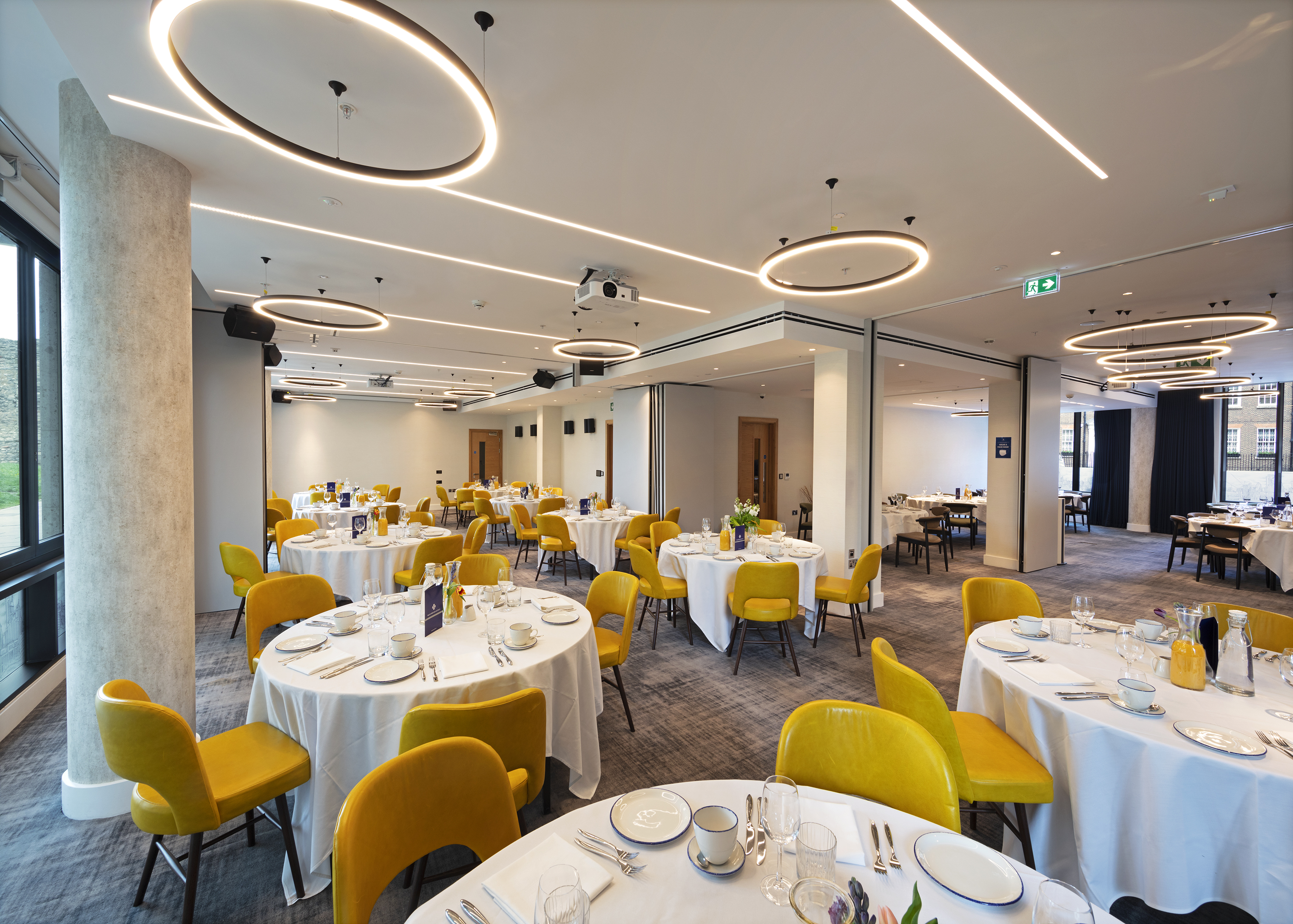 Modern event spaces in hotels with boardroom table and presentation screen